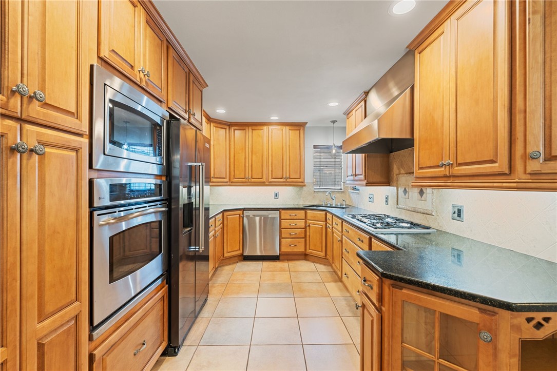 5121 Moultrie Drive Corpus Christi, TX 78413 - Photo 7 of 13 a kitchen with granite countertop a stove a sink and a refrigerator