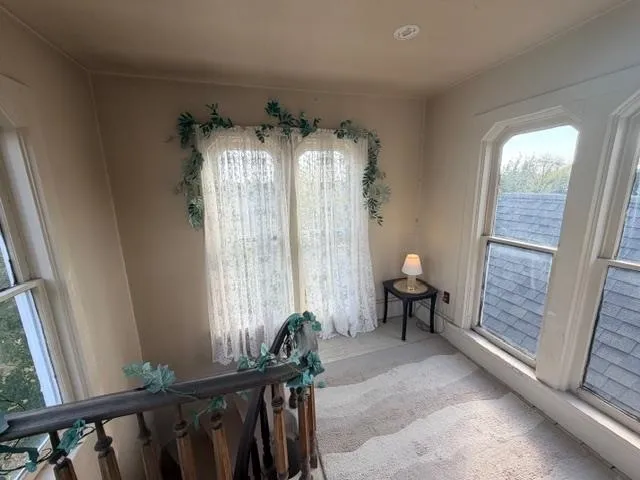 a view of a room with furniture and a window