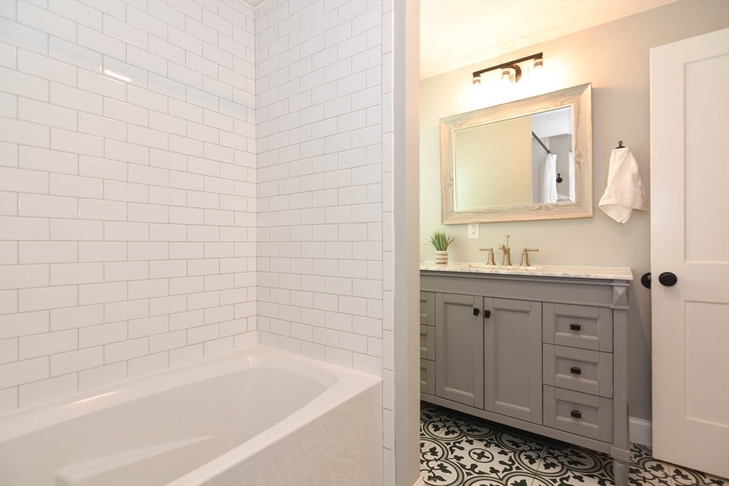 57 Parham Road Tyngsborough, MA 01879 - Photo 11 of 42 a bathroom with a granite countertop sink a toilet and bathtub