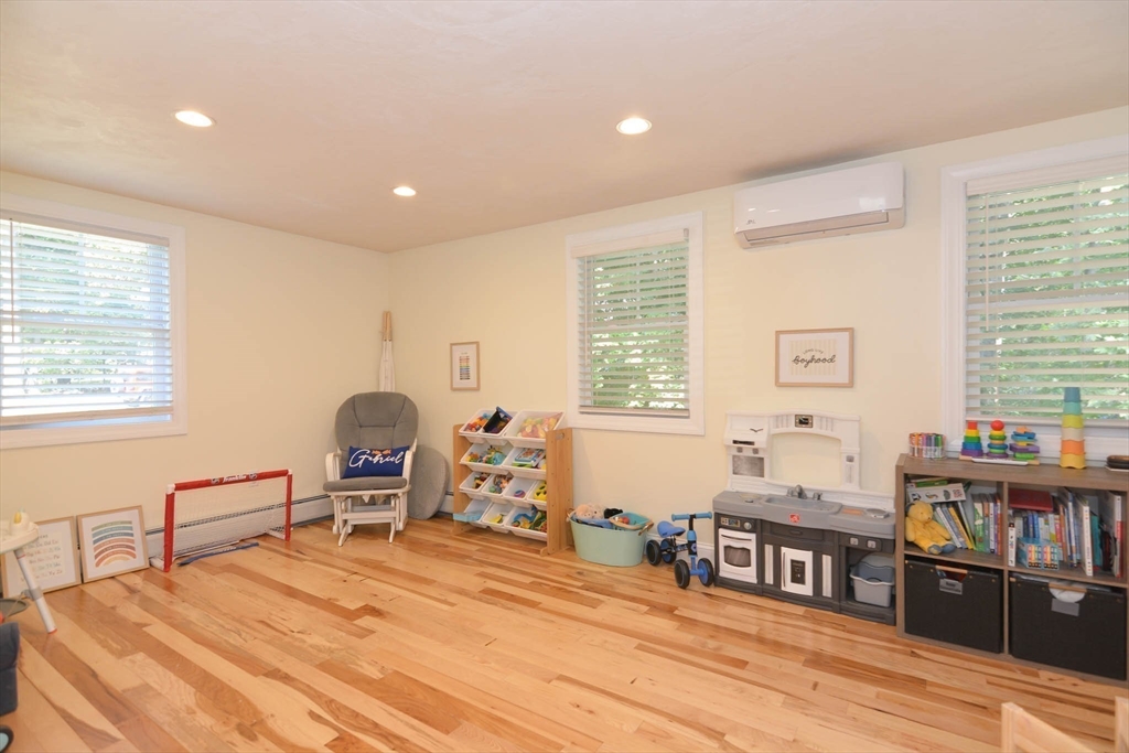 57 Parham Road Tyngsborough, MA 01879 - Photo 13 of 42 a bedroom with a bed and wooden floor