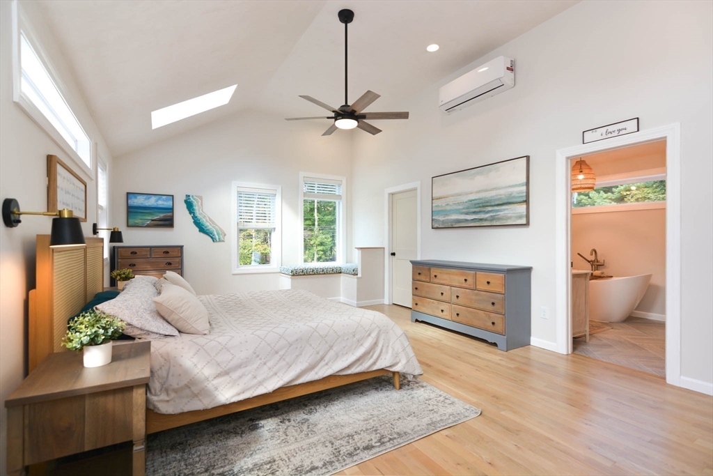 57 Parham Road Tyngsborough, MA 01879 - Photo 15 of 42 a spacious bedroom with a bed chandelier and a window