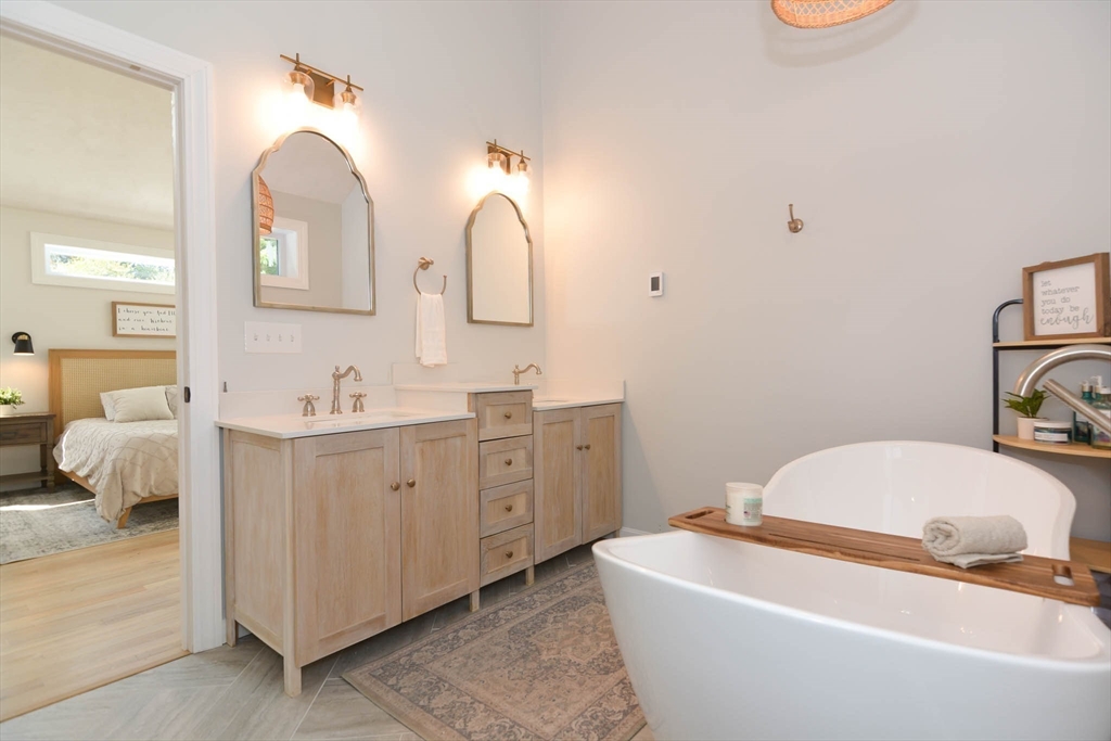 57 Parham Road Tyngsborough, MA 01879 - Photo 18 of 42 a spacious bathroom with 2 sink bathtub and a mirror