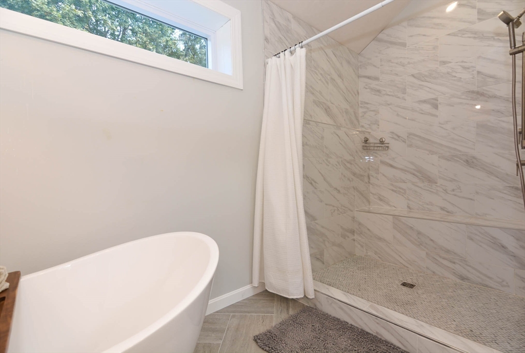 57 Parham Road Tyngsborough, MA 01879 - Photo 21 of 42 a bathroom with a white bath tub and a shower curtain