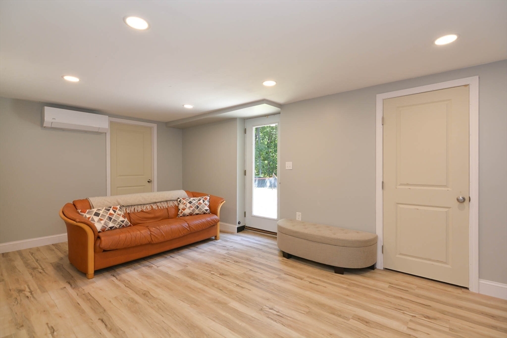 57 Parham Road Tyngsborough, MA 01879 - Photo 28 of 42 a living room with furniture and a wooden floor
