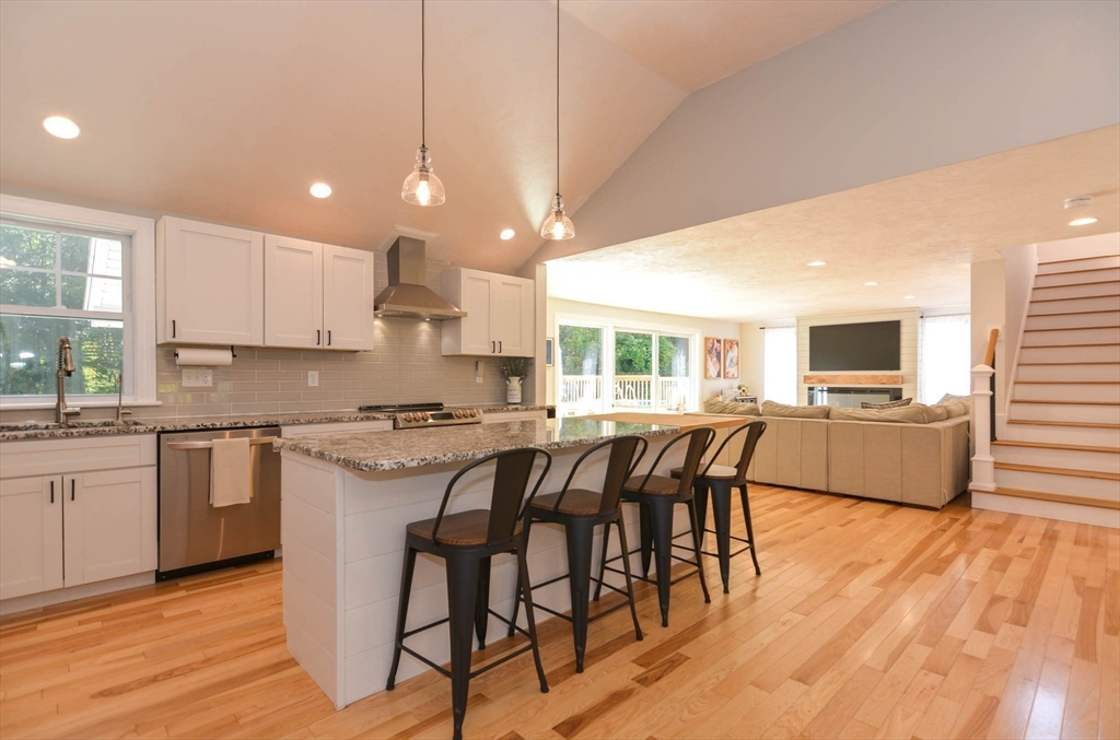 57 Parham Road Tyngsborough, MA 01879 - Photo 3 of 42 a kitchen with stainless steel appliances granite countertop a stove top oven a sink dishwasher a dining table and chairs with wooden floor