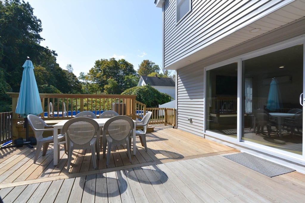57 Parham Road Tyngsborough, MA 01879 - Photo 31 of 42 a view of a patio with table and chairs with wooden floor and fence