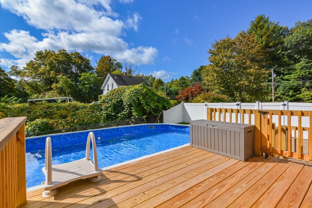 57 Parham Road Tyngsborough, MA 01879 - Photo 32 of 42 a view of a wooden deck and a yard