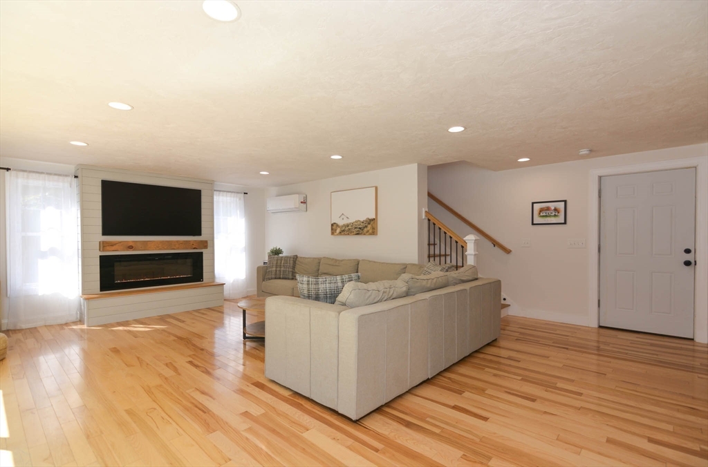 57 Parham Road Tyngsborough, MA 01879 - Photo 8 of 42 a living room with furniture and a flat screen tv