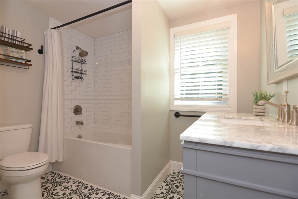 57 Parham Road Tyngsborough, MA 01879 - Photo 10 of 42 a bathroom with a granite countertop sink a toilet and shower