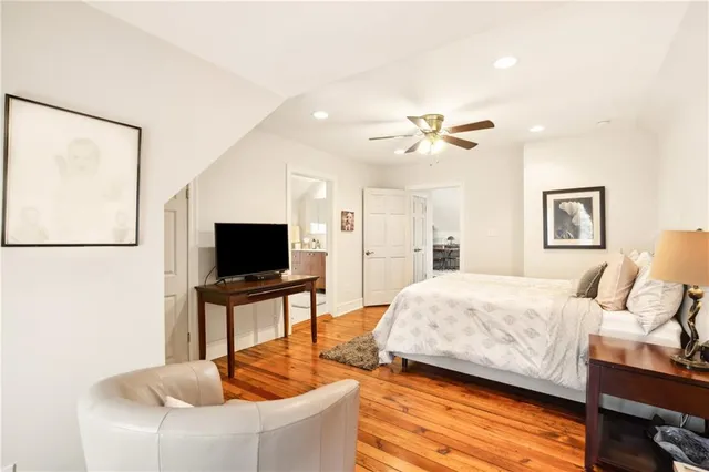 a spacious bathroom with a sink a toilet and a large mirror