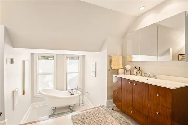 a view of hallway with bathroom and shower