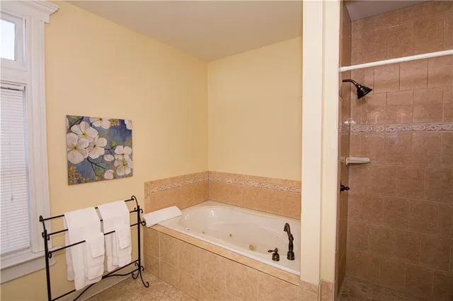 a bathroom with a granite countertop sink a toilet and bathtub
