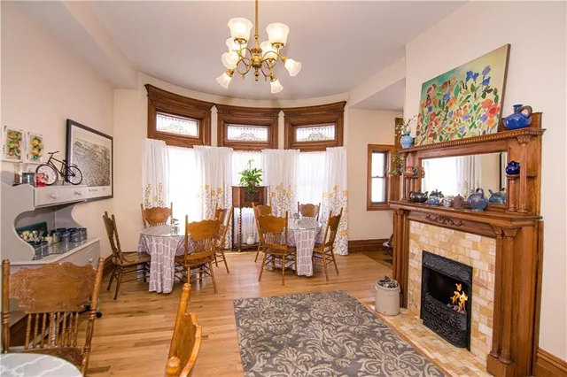 a dining room filled chandelier and wooden floor