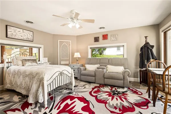 a bedroom with furniture and a chandelier