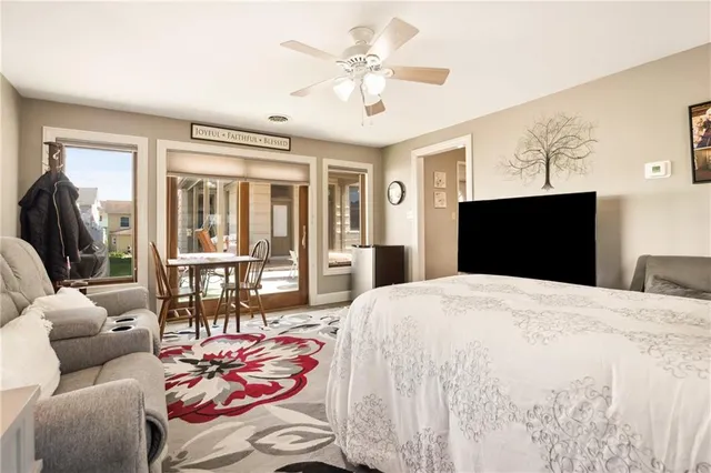 a bedroom with a bed and glass walk in closet