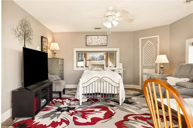 a bedroom with a bed and a flat screen tv