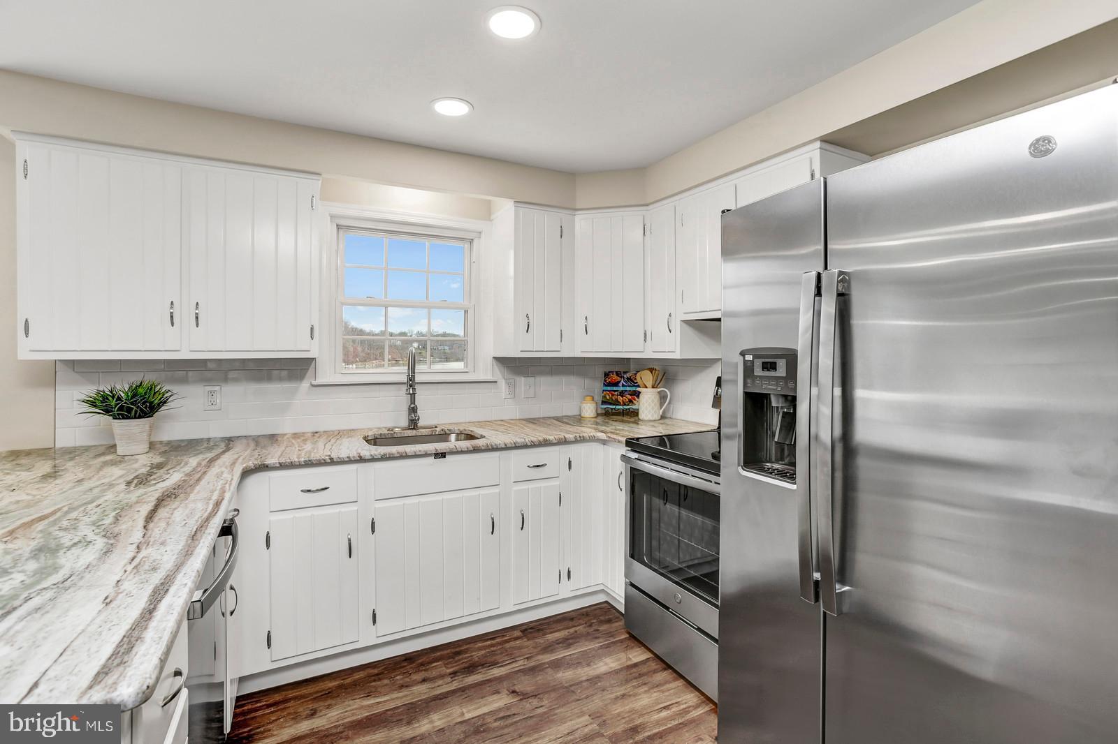 2732 Cedar Drive Riva, MD 21140 - Photo 12 of 30 a kitchen with white cabinets stainless steel appliances and a sink
