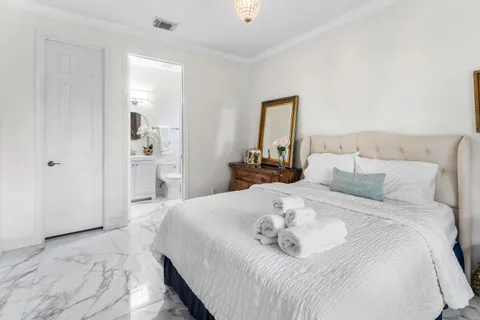 a bedroom with a bed and a painting on the wall