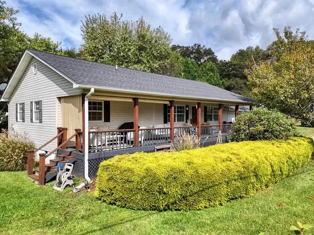 a view of a house with a yard patio and swimming pool