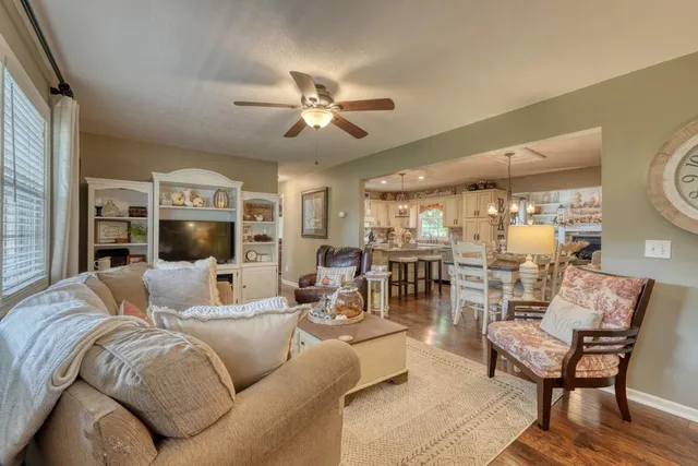a kitchen with kitchen island granite countertop a sink cabinets and window