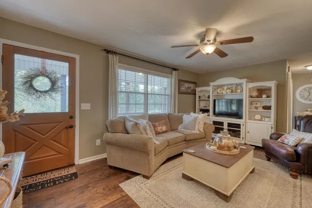 a kitchen with stainless steel appliances granite countertop white cabinets and window
