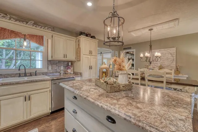 a view of a dining room with furniture wooden floor and chandelier