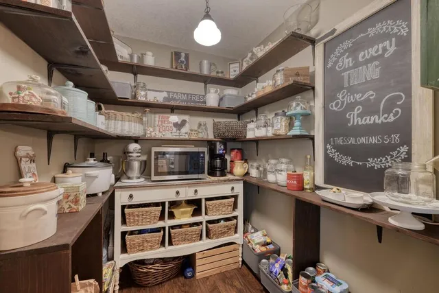 a living room with furniture a fireplace and a chandelier