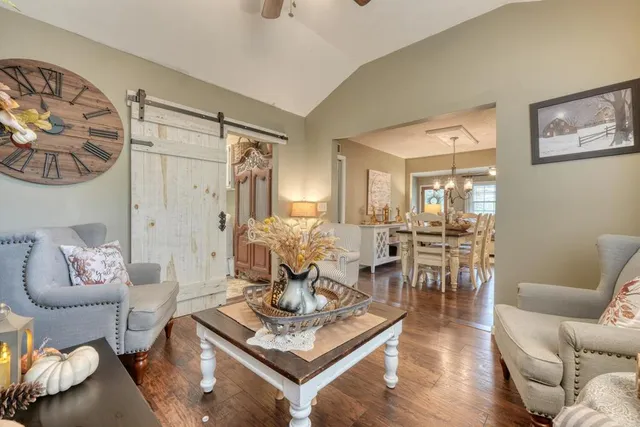 a bedroom with a large bed and a tv on dresser