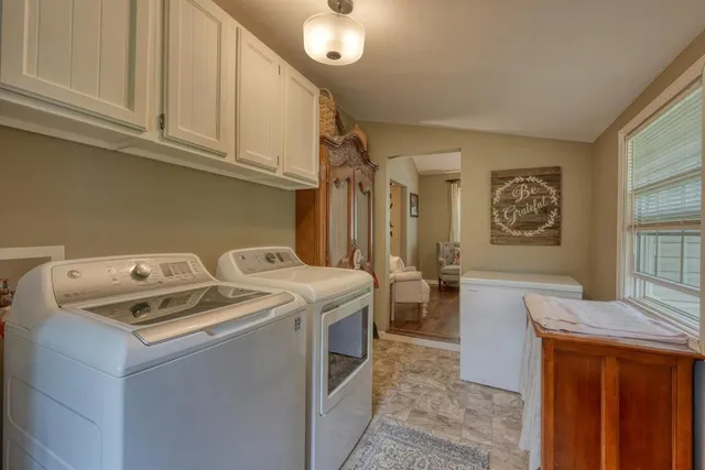 a bedroom with a bed and a chair with the potted plant