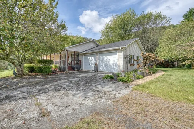 a view of a house with yard and a garden
