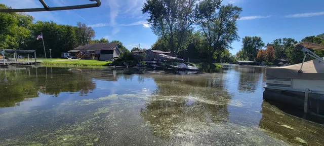 a view of a house with a yard from a lake view