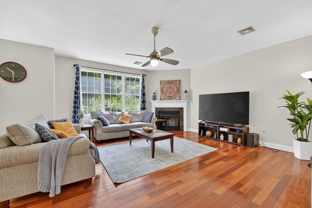 15 Evergreen Circle, Unit 15 Canton, MA 02021 - Photo 6 of 29 a living room with furniture a fireplace and a flat screen tv