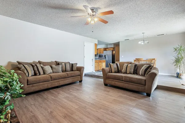 a living room with furniture and a chandelier