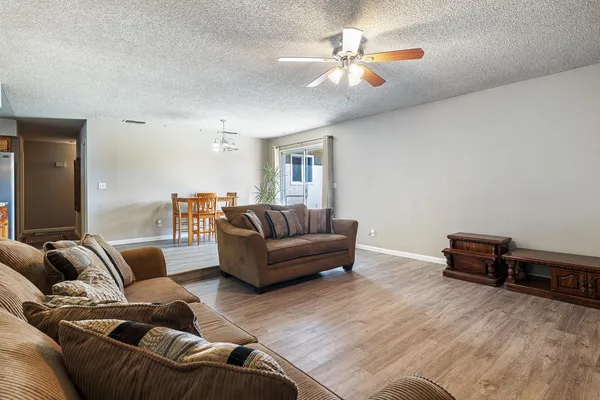 a living room with furniture and a chandelier