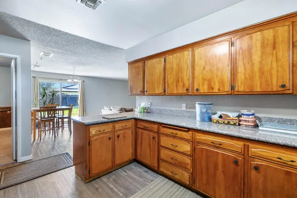 a kitchen with stainless steel appliances granite countertop wooden cabinets a sink and dishwasher