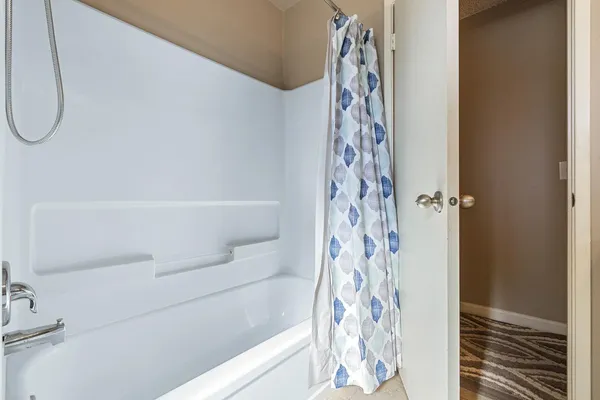 a bathroom with a bathtub and shower