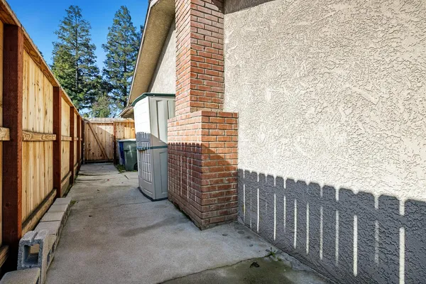 a view of a pathway of a building with wooden fence and stairs