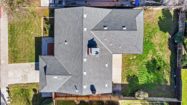a aerial view of a house with a yard