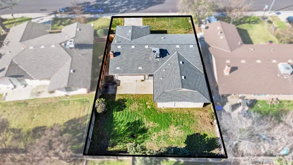 an aerial view of a house with a yard