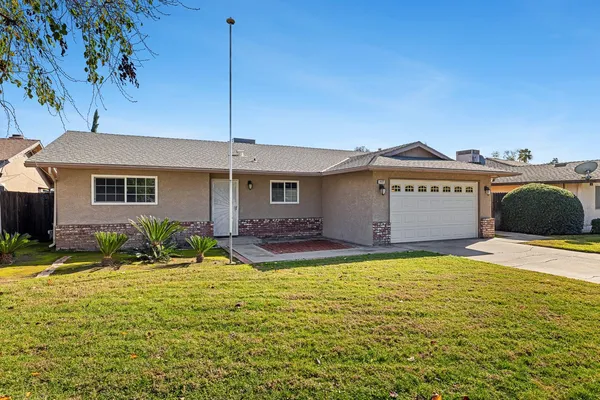 a view of a house with pool and yard