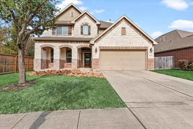 a front view of a house with a yard and garage