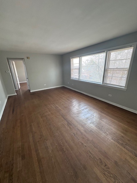 2907 West 59th Street, Unit 3S Chicago, IL 60629 - Photo 2 of 9 an empty room with wooden floor and windows