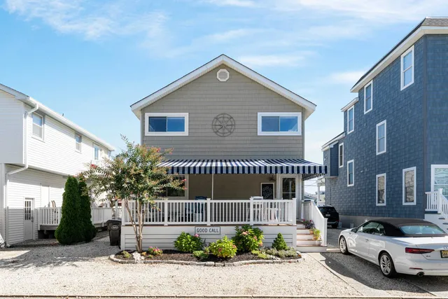 an aerial view of a house with a swimming pool and outdoor seating