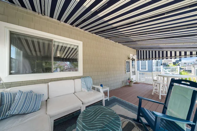 a kitchen with stainless steel appliances granite countertop a refrigerator a sink a stove a dining table and chairs with wooden floor