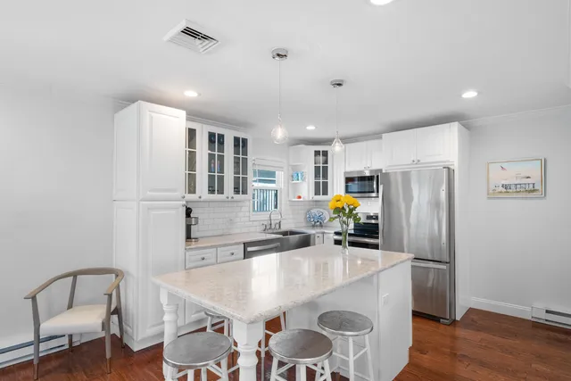 a kitchen with stainless steel appliances a sink stove and refrigerator