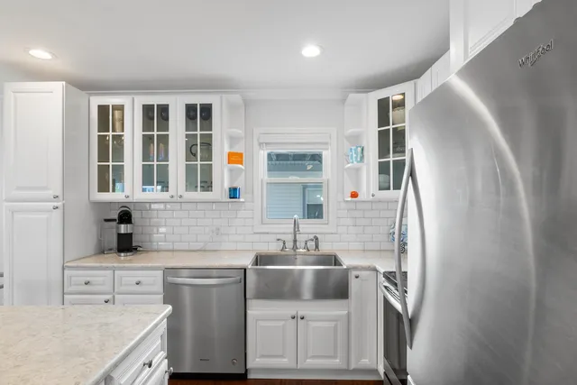 a kitchen with a sink cabinets and stainless steel appliances