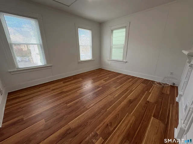 a view of room with wooden floor