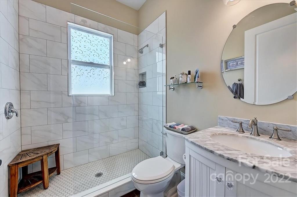 2557 Hidden Shoals Road Fort Mill, SC 29708 - Photo 13 of 30 a bathroom with a granite countertop sink a toilet and a mirror
