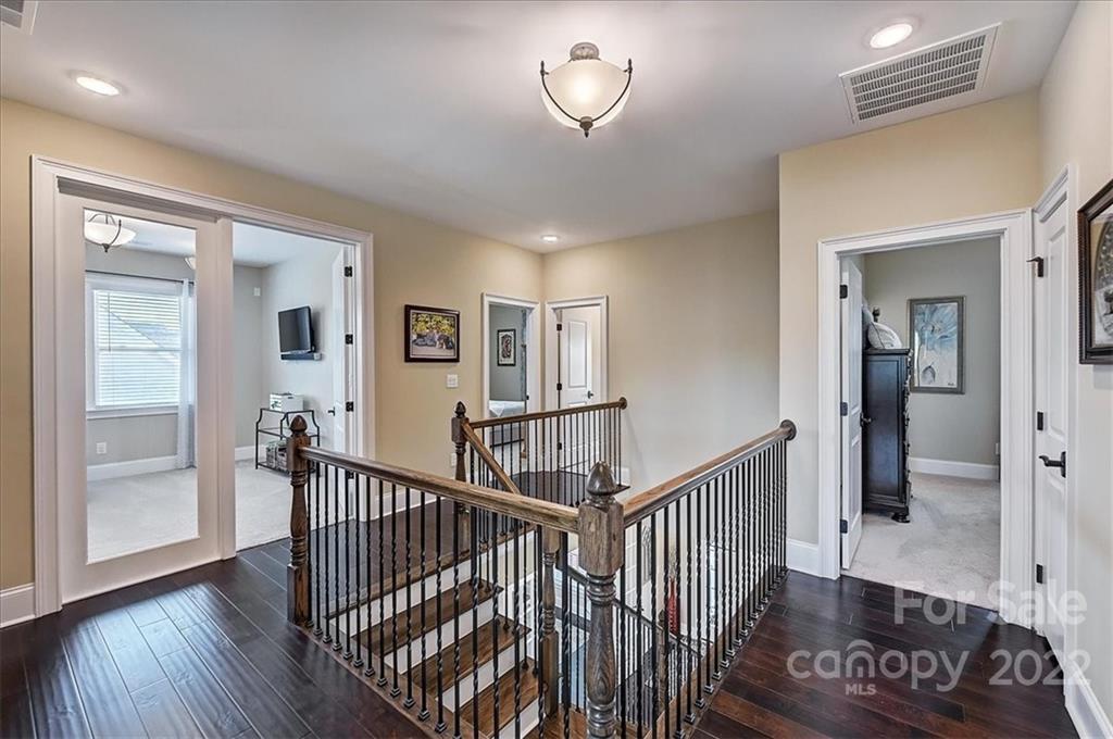 2557 Hidden Shoals Road Fort Mill, SC 29708 - Photo 18 of 30 a view of a hallway with wooden floor and stairs