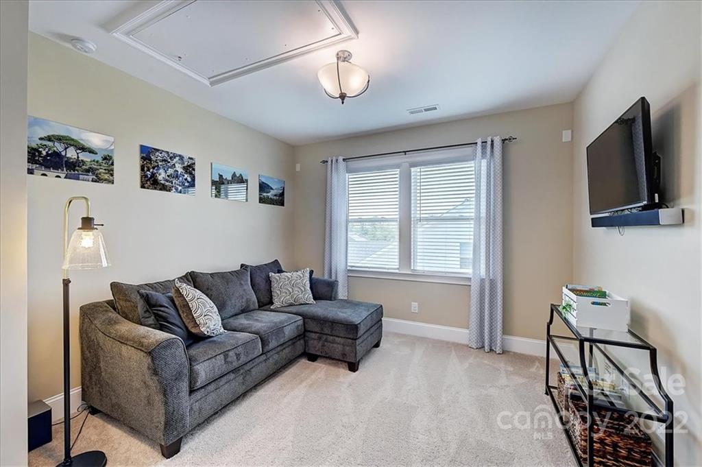 2557 Hidden Shoals Road Fort Mill, SC 29708 - Photo 26 of 30 a living room with furniture and a flat screen tv